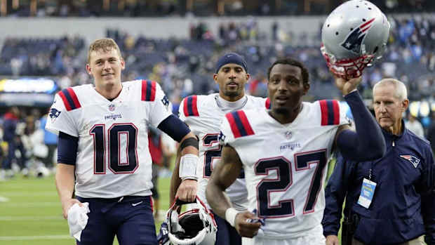 Patriots QB Mac Jones (10) and Cornerback J.C. Jackson (27)